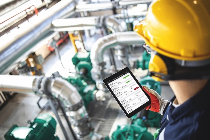 Next to the text on the topic of “Industry” is a small image showing a hand holding a tablet against a blurred factory background. The tablet displays numbers and graphs.